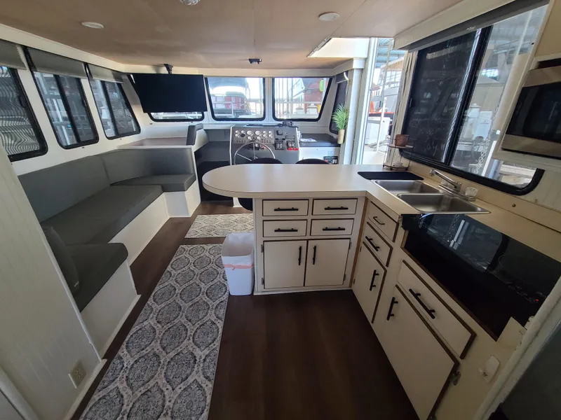 Slide: The Image of Interior of a 1993 Gibson SPORT SERIES boat with kitchen and seating area. - 22