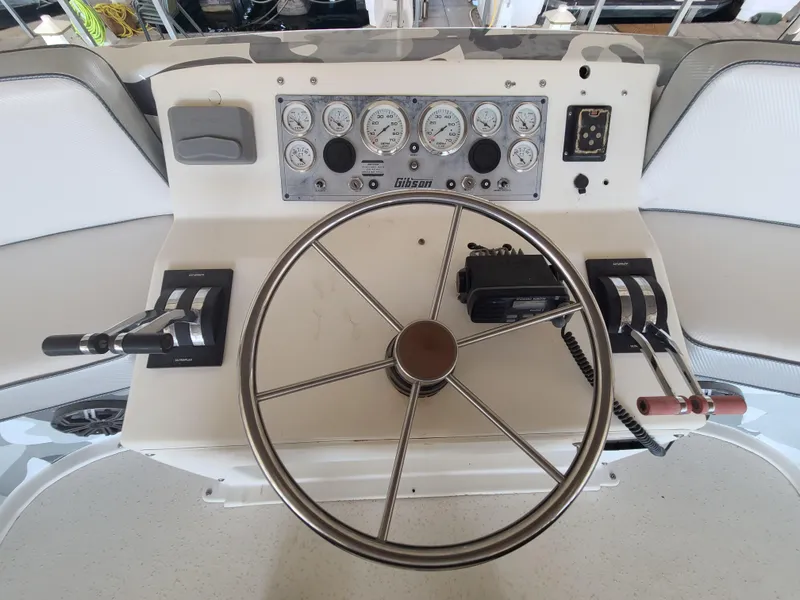 Slide: The Image of 1993 Gibson SPORT SERIES boat helm with steering wheel and control panel. - 26