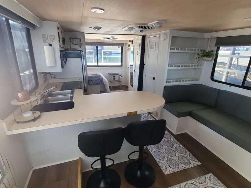 Slide: The Image of 1993 Gibson SPORT SERIES interior with modern kitchen, seating area, and natural light. - 7