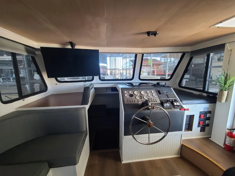 Slide: The Image of Interior of a 1993 Gibson SPORT SERIES boat with helm, seating, and modern controls. - 9