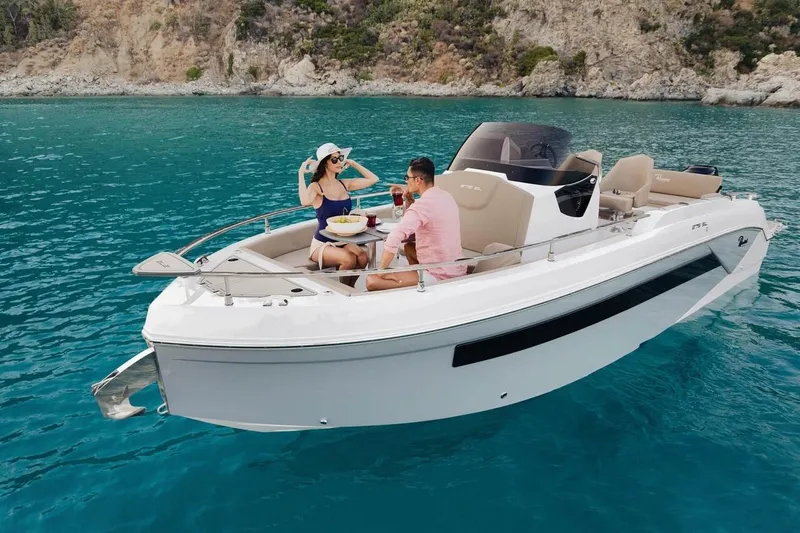 The Image of 2025 Ranieri 275 LS boat on clear blue water with people enjoying a sunny day. - 0
