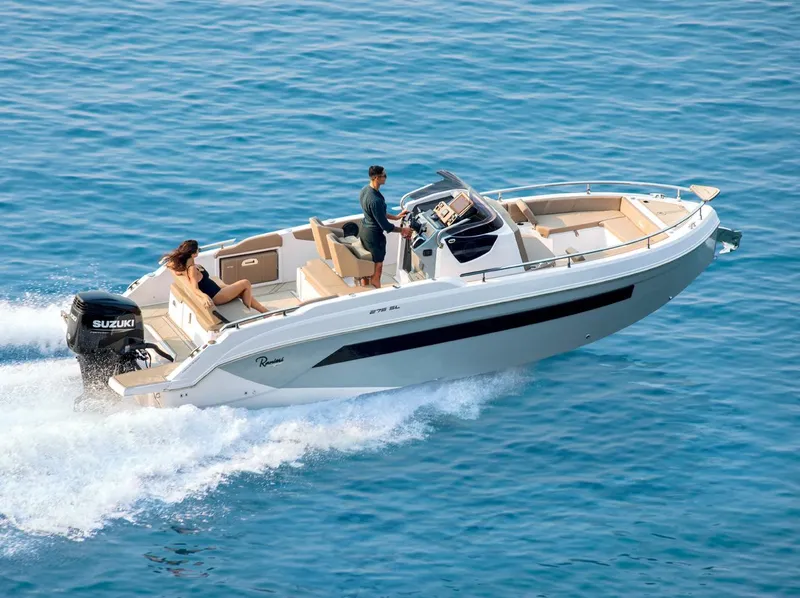 Slide: The Image of 2025 Ranieri 275 LS boat cruising on open water with passengers. - 2