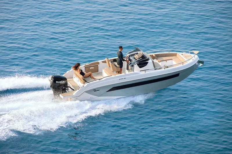 Slide: The Image of 2025 Ranieri 275 LS motorboat cruising on open blue water. - 5