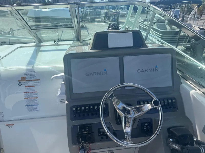 Slide: The Image of 2018 Robalo R305 Walkaround helm with Garmin displays and steering wheel. - 10