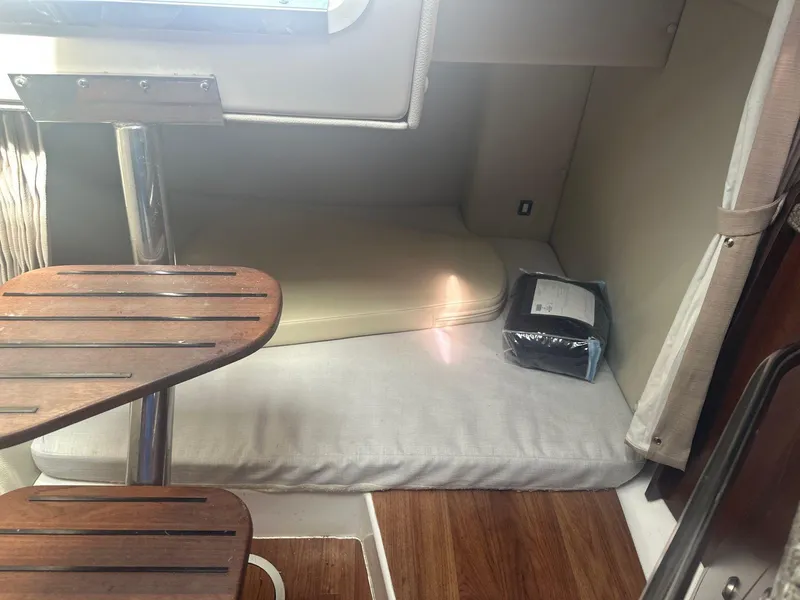 Slide: The Image of Interior cabin of 2018 Robalo R305 Walkaround boat with wooden steps and cushions. - 13