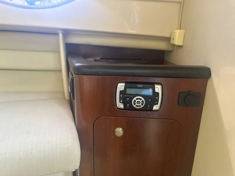 Slide: The Image of Interior of 2018 Robalo R305 Walkaround boat with wood cabinet and audio system. - 17