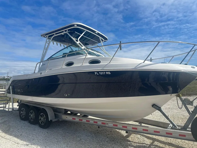 Slide: The Image of 2018 Robalo R305 Walkaround boat on trailer under blue sky. - 4