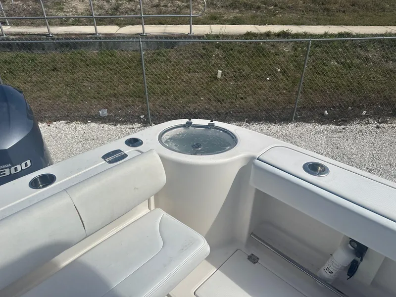 Slide: The Image of 2018 Robalo R305 Walkaround boat interior with seating and storage compartments. - 7