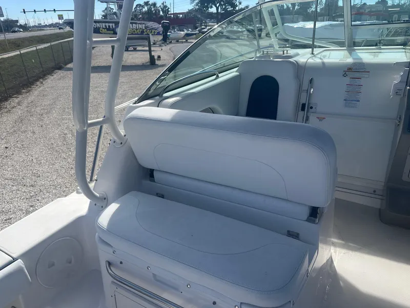 Slide: The Image of 2018 Robalo R305 Walkaround boat interior with white seating and helm area. - 8