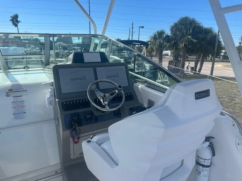 Slide: The Image of 2018 Robalo R305 Walkaround helm with Garmin displays and steering wheel. - 9