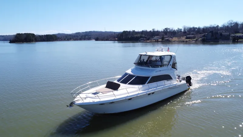 Slide: The Image of 2001 Sea Ray 480 Sedan Bridge yacht cruising on a serene lake. - 14