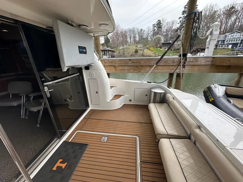 Slide: The Image of 2001 Sea Ray 480 Sedan Bridge yacht deck with seating and water view. - 20