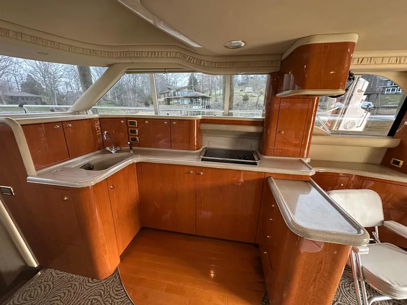 Slide: The Image of Luxurious kitchen interior of 2001 Sea Ray 480 Sedan Bridge yacht with wooden cabinetry. - 22