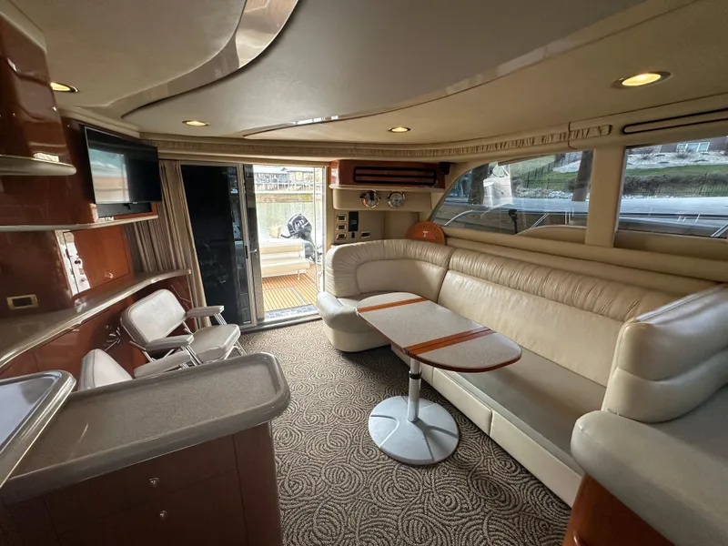 Slide: The Image of Luxurious interior of 2001 Sea Ray 480 Sedan Bridge yacht with elegant seating and modern amenities. - 23