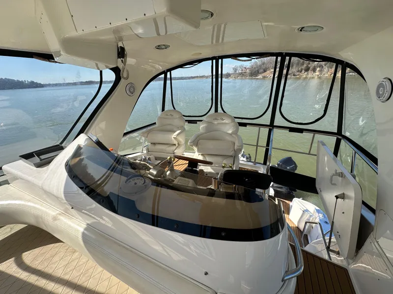Slide: The Image of Interior view of 2001 Sea Ray 480 Sedan Bridge yacht with helm and seating. - 26