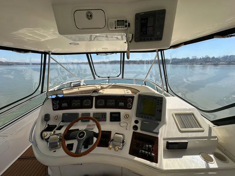 Slide: The Image of 2001 Sea Ray 480 Sedan Bridge helm with navigation instruments and panoramic water view. - 27