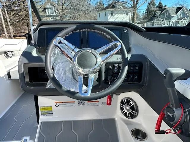Slide: The Image of 2025 Regal LS4 Surf boat dashboard with steering wheel and control panel. - 10