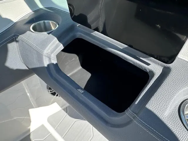 Slide: The Image of 2025 Regal LS4 Surf boat interior storage compartment with cup holder. - 14