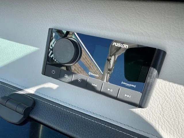 Slide: The Image of Fusion audio system in 2025 Regal LS4 Surf boat, featuring Bluetooth and SiriusXM connectivity. - 15