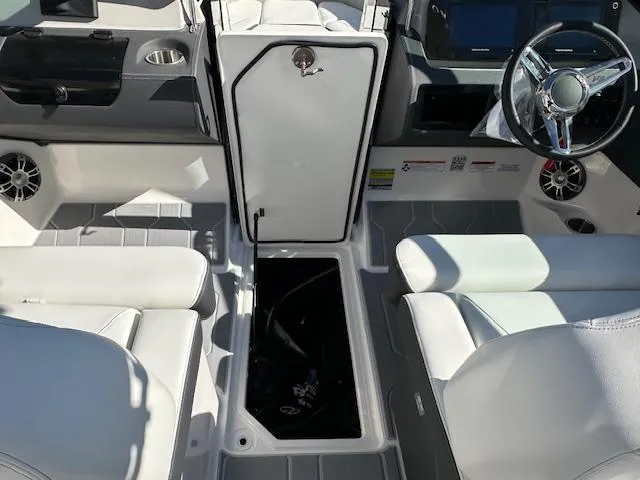 Slide: The Image of 2025 Regal LS4 Surf boat interior with white seating and modern dashboard. - 19