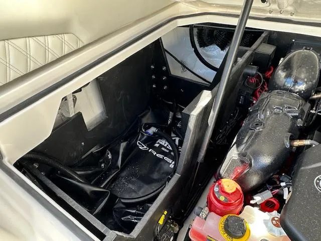 Slide: The Image of 2025 Regal LS4 Surf engine compartment with visible components and storage area. - 26