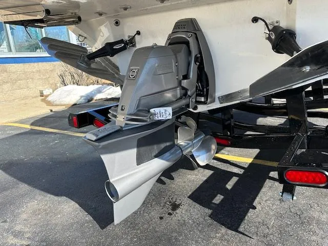 Slide: The Image of 2025 Regal LS4 Surf boat's stern drive and propeller in a parking lot. - 28