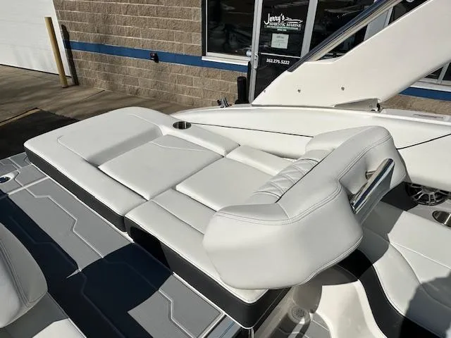 Slide: The Image of 2025 Regal LS4 Surf boat with white leather seating and sleek design. - 7