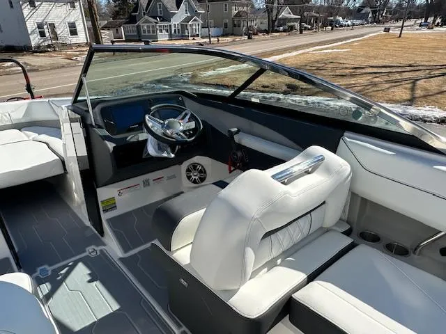Slide: The Image of 2025 Regal LS4 Surf boat interior with white seating and modern dashboard. - 8