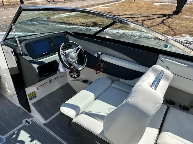 Slide: The Image of 2025 Regal LS4 Surf boat interior with modern dashboard and white seating. - 9