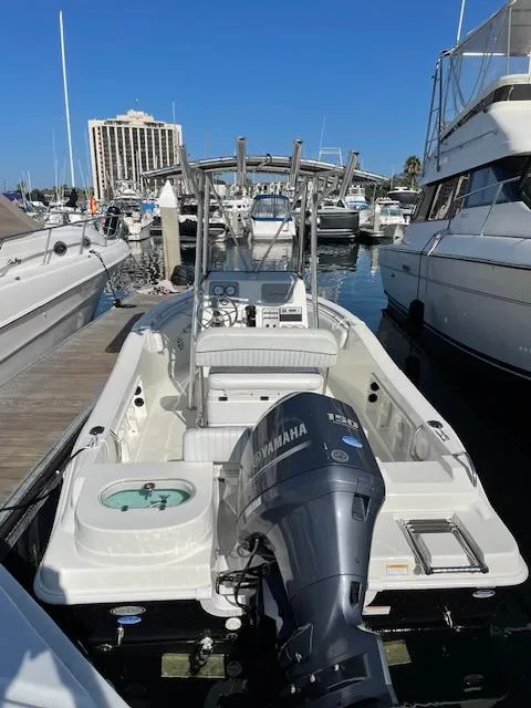 Slide: The Image of 2014 NauticStar 1900 XS boat docked, featuring Yamaha outboard motor, in a marina setting. - 11