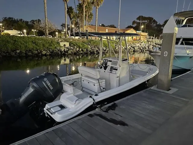 Slide: The Image of 2014 NauticStar 1900 XS boat docked at marina during evening. - 14