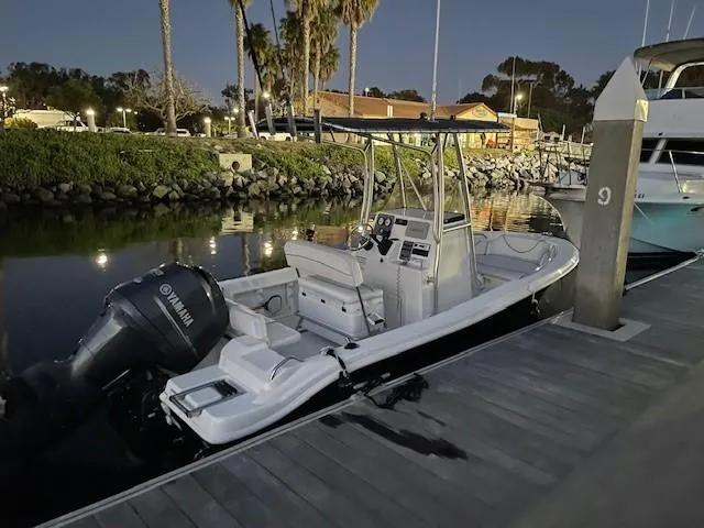 Slide: The Image of 2014 NauticStar 1900 XS boat docked at marina during evening. - 17