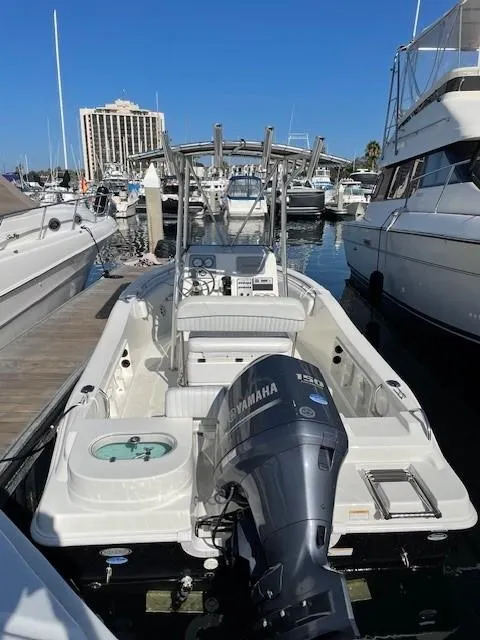 Slide: The Image of 2014 NauticStar 1900 XS boat docked with Yamaha outboard motor, surrounded by other boats. - 18