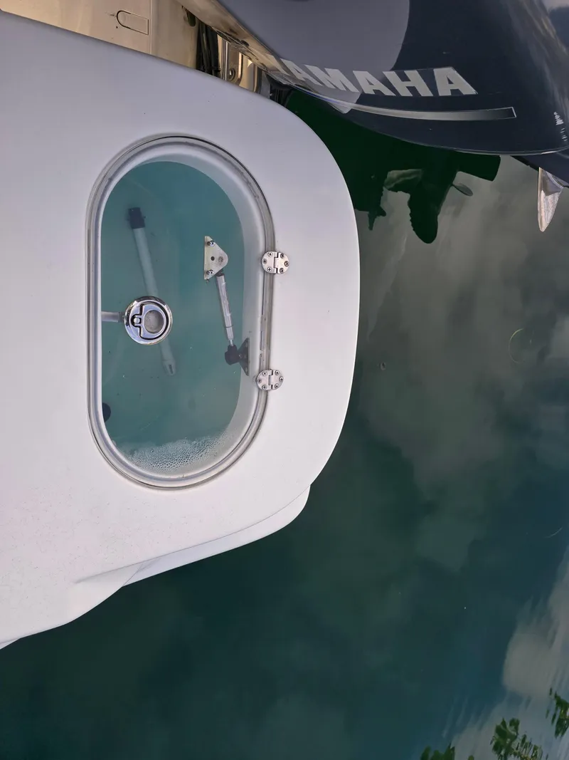 Slide: The Image of 2014 NauticStar 1900 XS boat with Yamaha engine, docked on calm water. - 6