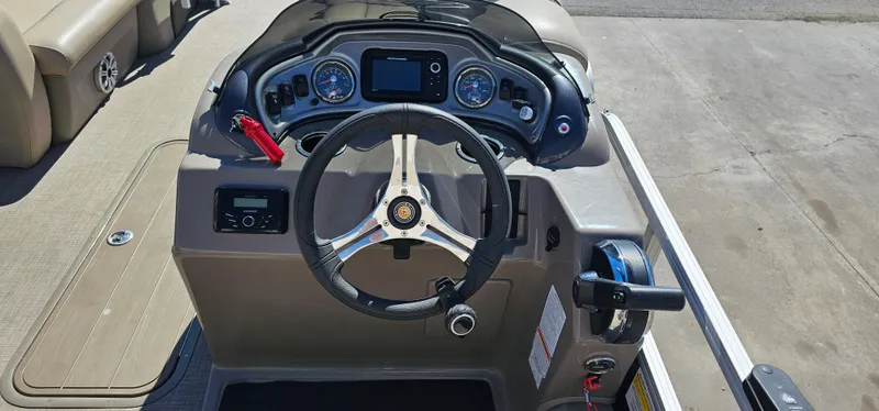 Slide: The Image of 2023 Sun Tracker SF-22XP3 boat dashboard with steering wheel and control panel. - 11
