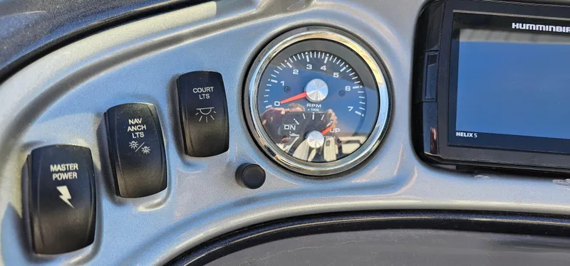 Slide: The Image of Control panel of 2023 Sun Tracker SF-22XP3 boat with gauges and switches. - 13