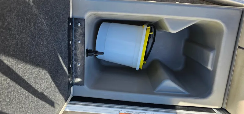 Slide: The Image of Storage compartment with a bucket inside a 2023 Sun Tracker SF-22XP3 boat. - 26