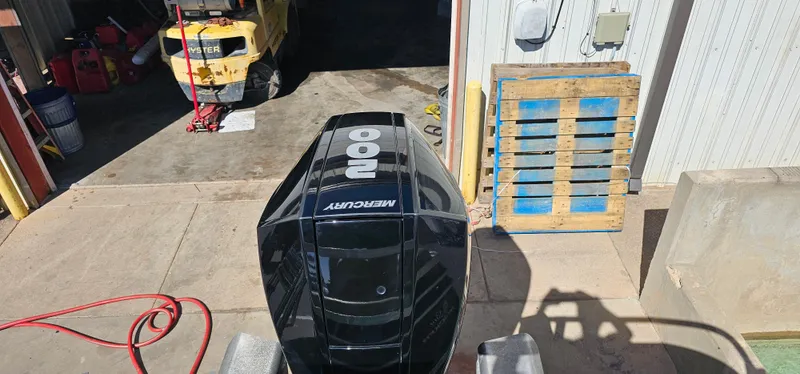 Slide: The Image of 2023 Sun Tracker SF-22XP3 with Mercury outboard engine in a workshop setting. - 28