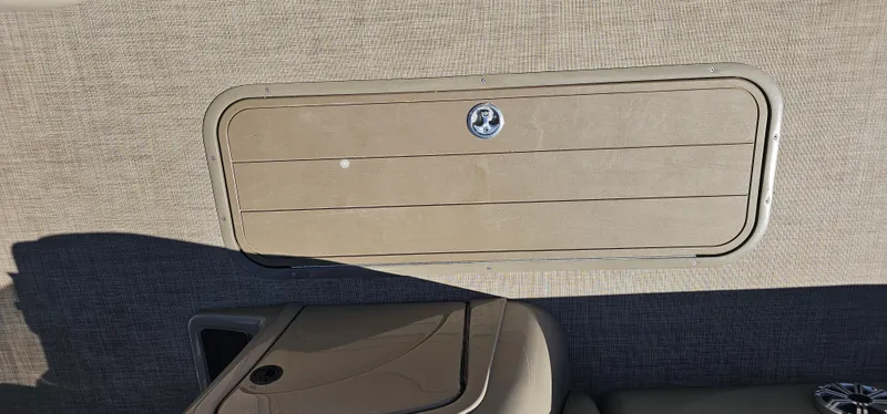 Slide: The Image of 2023 Sun Tracker SF-22XP3 interior storage compartment with beige paneling. - 29