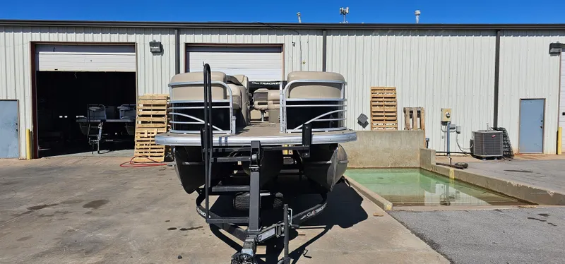Slide: The Image of 2023 Sun Tracker SF-22XP3 pontoon boat parked outside a warehouse. - 3