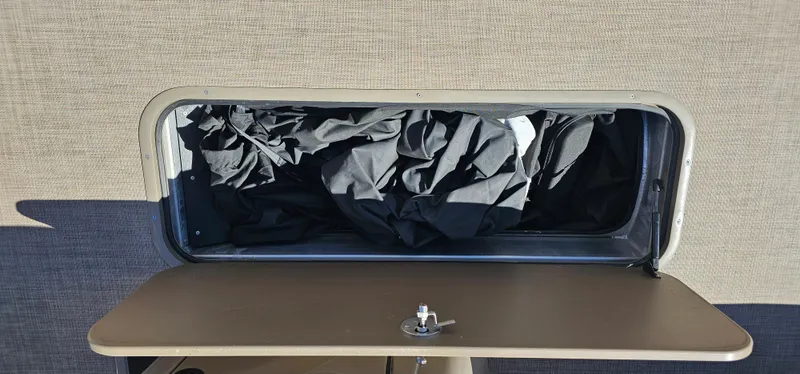 Slide: The Image of Storage compartment of 2023 Sun Tracker SF-22XP3 boat with black fabric inside. - 30