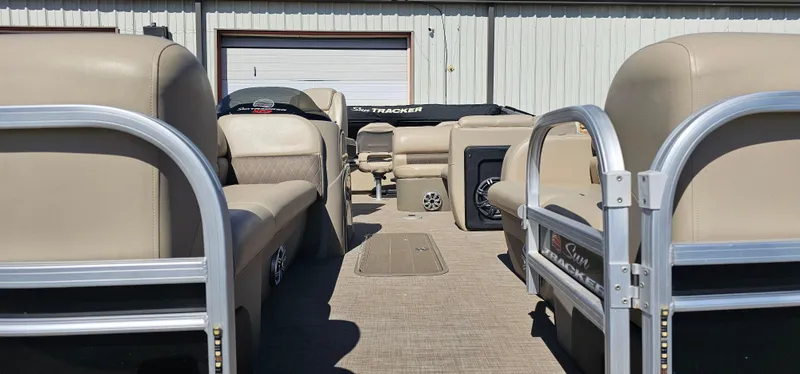 Slide: The Image of 2023 Sun Tracker SF-22XP3 pontoon boat interior with beige seating and metal railings. - 4