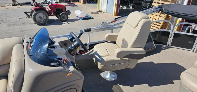 Slide: The Image of 2023 Sun Tracker SF-22XP3 boat interior with steering wheel and captain's chair. - 9