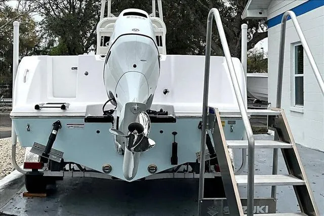 Slide: The Image of 2025 Aquasport 2200 Center Console boat with Suzuki outboard motor, rear view. - 16