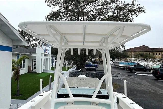 Slide: The Image of 2025 Aquasport 2200 Center Console boat with T-top, parked outdoors. - 20
