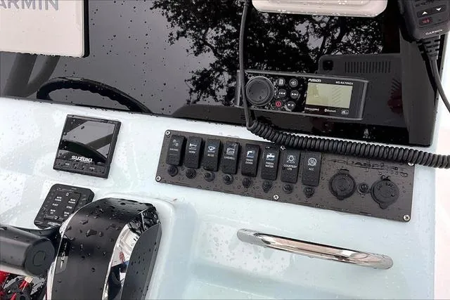 Slide: The Image of Control panel of 2025 Aquasport 2200 Center Console with navigation and communication equipment. - 25