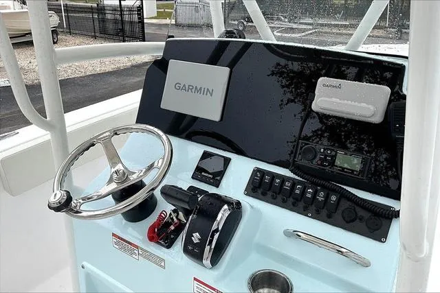 Slide: The Image of 2025 Aquasport 2200 Center Console dashboard with Garmin navigation system and controls. - 26