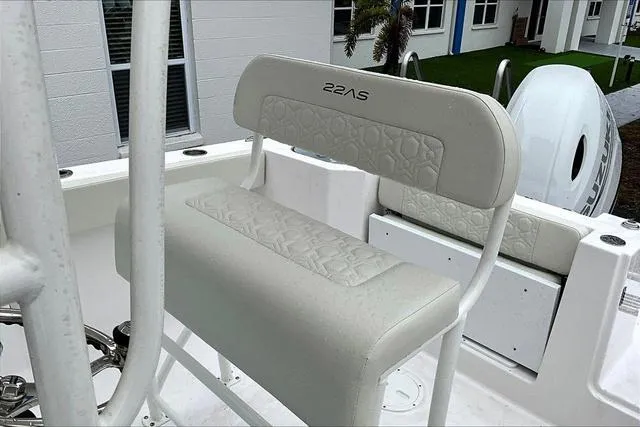 Slide: The Image of 2025 Aquasport 2200 Center Console boat seat with white cushioned design. - 28