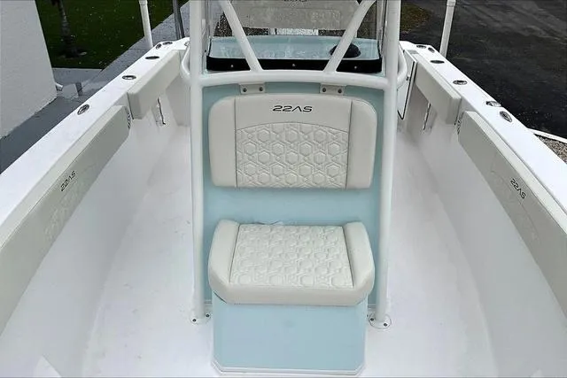 Slide: The Image of 2025 Aquasport 2200 Center Console boat interior with cushioned seating and sleek design. - 29