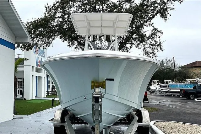 Slide: The Image of 2025 Aquasport 2200 Center Console boat on trailer, parked outdoors. - 32